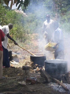 Large pots of rice cook over open fires